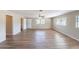 Open-concept living room featuring updated floors, natural light, and an open doorway to another room at 5600 Arundel Dr, Orlando, FL 32808