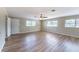 Spacious living room featuring updated floors, a ceiling fan, and natural light from multiple windows at 5600 Arundel Dr, Orlando, FL 32808