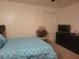 Bedroom with a blue patterned bedspread, a dresser with a tv, and light colored walls at 625 Dory Ln # 204, Altamonte Springs, FL 32714