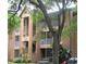 Condominium exterior with balconies and mature trees in a well-maintained community at 625 Dory Ln # 204, Altamonte Springs, FL 32714