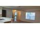 Bright living room adjacent to kitchen with a large window, ceiling fan, and neutral flooring at 625 Dory Ln # 204, Altamonte Springs, FL 32714
