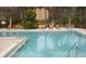 A large community pool is surrounded by chairs and tables for residents at 625 Dory Ln # 204, Altamonte Springs, FL 32714