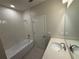 Bathroom featuring a tiled bathtub and shower combo, and a vanity at 628 Pothos St, Apopka, FL 32703