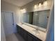 Large bathroom featuring double sinks, granite counters, and decorative lighting fixtures at 628 Pothos St, Apopka, FL 32703