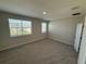 Bright bedroom with large windows, neutral carpet, and a closet at 628 Pothos St, Apopka, FL 32703