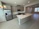 Modern kitchen with stainless steel appliances, gray cabinets, granite countertops, and tile flooring at 628 Pothos St, Apopka, FL 32703
