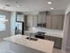 Modern kitchen features stainless steel appliances, granite countertops, and gray cabinets at 628 Pothos St, Apopka, FL 32703