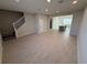 Open-concept living room with tile floors, a staircase, and abundant natural light at 628 Pothos St, Apopka, FL 32703