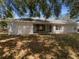 Rear exterior view featuring sliding glass doors and windows, with a spacious backyard at 640 Westview Dr, Minneola, FL 34715