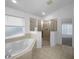 Bathroom with a separate shower and tub, offering a relaxing and functional space at 640 Westview Dr, Minneola, FL 34715