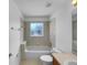 Bright bathroom featuring a tub and shower combination, neutral tiles, and good natural light at 640 Westview Dr, Minneola, FL 34715