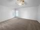 Bright, carpeted bedroom showcasing ample space and natural light from large windows at 640 Westview Dr, Minneola, FL 34715