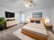 Cozy bedroom featuring a modern wooden bed frame, stylish decor, and ample natural light from the windows at 640 Westview Dr, Minneola, FL 34715