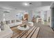 Bright living room with white sofa, striped rug, and open floor plan leading to the kitchen and dining area at 640 Westview Dr, Minneola, FL 34715