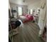 Bright bedroom featuring wood floors and pink bedding at 6434 Cava Alta Dr # 303, Orlando, FL 32835