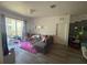 Spacious living room with wood floors, ample seating, and balcony access at 6434 Cava Alta Dr # 303, Orlando, FL 32835