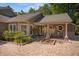 Charming home entrance with a brick pathway, rocking chairs on the porch, and a unique round window at 677 Benitawood Ct, Winter Springs, FL 32708