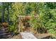 Secluded gazebo surrounded by lush tropical plants offers a tranquil escape in this beautifully landscaped backyard at 677 Benitawood Ct, Winter Springs, FL 32708