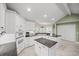 Well-lit kitchen with white cabinets, granite countertops, stainless steel appliances, and tiled floors at 677 Benitawood Ct, Winter Springs, FL 32708