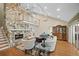Bright living room with soaring ceilings, stone fireplace, and wood floors at 677 Benitawood Ct, Winter Springs, FL 32708