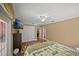 This main bedroom has a ceiling fan, carpet, a large closet with doors, and access to the main bathroom at 677 Benitawood Ct, Winter Springs, FL 32708