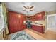 This office features a ceiling fan, custom cabinetry, a built-in desk, and hardwood floors at 677 Benitawood Ct, Winter Springs, FL 32708