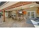 Inviting outdoor bar featuring seating, a TV, ceiling fans, and travertine flooring, ideal for entertaining guests at 677 Benitawood Ct, Winter Springs, FL 32708