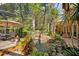 Lush landscaping surrounds a screened-in pool, creating a serene oasis for relaxation and enjoyment at 677 Benitawood Ct, Winter Springs, FL 32708
