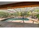 Relaxing screened-in pool and patio surrounded by lush landscaping offers a private outdoor retreat at 677 Benitawood Ct, Winter Springs, FL 32708