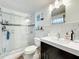This well-lit bathroom offers a sink, and glass shower, and tiled floors at 702 E Church St # 3, Orlando, FL 32801