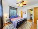 Bedroom features ceiling fan, two windows, closet and ensuite laundry area at 702 E Church St # 3, Orlando, FL 32801