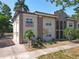 Two-story condominium featuring a Mediterranean-style design with an inviting walkway and mature landscaping at 702 E Church St # 3, Orlando, FL 32801