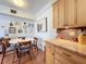Eating area includes wood floors, decor wall, round table with seating and kitchen storage at 702 E Church St # 3, Orlando, FL 32801
