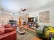 A view of a living room with a desk, a green rug, ceiling fan, and comfortable seating at 702 E Church St # 3, Orlando, FL 32801