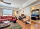A comfortable living room space with wood floors, a sofa, a work desk, and a view into the bedroom at 702 E Church St # 3, Orlando, FL 32801