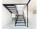 Apartment stairwell with black metal stairs and railings, showing mailboxes and a glimpse of the landing above at 702 E Church St # 3, Orlando, FL 32801