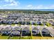 Aerial view of homes with yards in a Primary-planned community close to a lake and nature preserve at 7649 Ragusa Way, Clermont, FL 34714