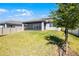 Spacious backyard featuring a well-maintained lawn and screened-in patio, perfect for outdoor enjoyment at 7649 Ragusa Way, Clermont, FL 34714