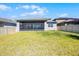 Well-maintained backyard with a screened patio, offering a comfortable outdoor living space at 7649 Ragusa Way, Clermont, FL 34714