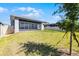 Lush backyard with a screened patio, providing a serene and private outdoor retreat at 7649 Ragusa Way, Clermont, FL 34714