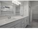 Elegant bathroom with double vanity, quartz counters, modern fixtures, and tiled walk-in shower at 7649 Ragusa Way, Clermont, FL 34714