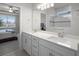 Elegant bathroom with double vanity, quartz counters, modern fixtures, walk-in shower and ensuite bedroom at 7649 Ragusa Way, Clermont, FL 34714