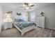 Inviting bedroom featuring floral bedding, coastal decor, and natural light from the window at 7649 Ragusa Way, Clermont, FL 34714