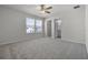Bedroom with a ceiling fan, plush gray carpet, and natural light from the window at 7649 Ragusa Way, Clermont, FL 34714