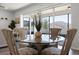 Dining area featuring glass table and wicker chairs, overlooking the screened-in lanai at 7649 Ragusa Way, Clermont, FL 34714
