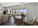 Dining area with a glass table, wicker chairs, and views of the screened-in lanai at 7649 Ragusa Way, Clermont, FL 34714