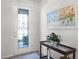 A decorative glass front door enhances the entryway complemented by an attractive table decor at 7649 Ragusa Way, Clermont, FL 34714