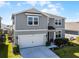Stylish two-story home with landscaped front yard and attached two-car garage in a great neighborhood at 7649 Ragusa Way, Clermont, FL 34714