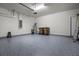 Spacious garage with epoxy flooring, providing a clean and functional space for vehicles and storage at 7649 Ragusa Way, Clermont, FL 34714