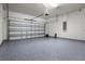 Clean, well-lit garage with epoxy flooring and ample space for parking and storage at 7649 Ragusa Way, Clermont, FL 34714